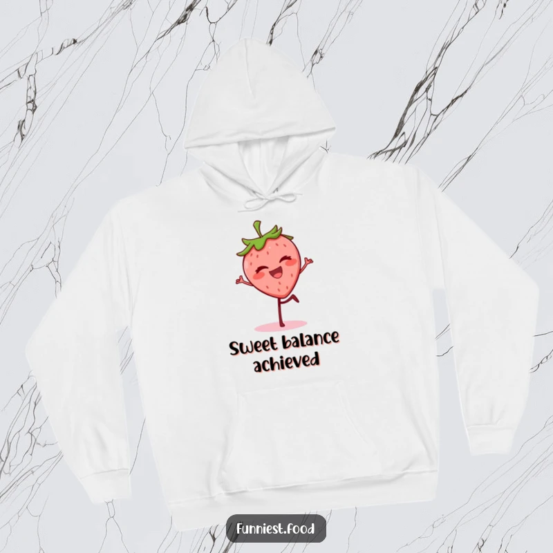Funny grinning strawberry balancing on one leg, winking on a cozy hoodie, a humorous and cheerful apparel.